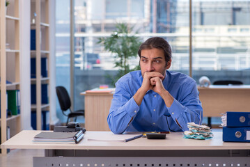 Young male bookkeeper in budget planning concept