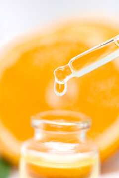 Orange essential oil on a white isolated background. Selective focus.