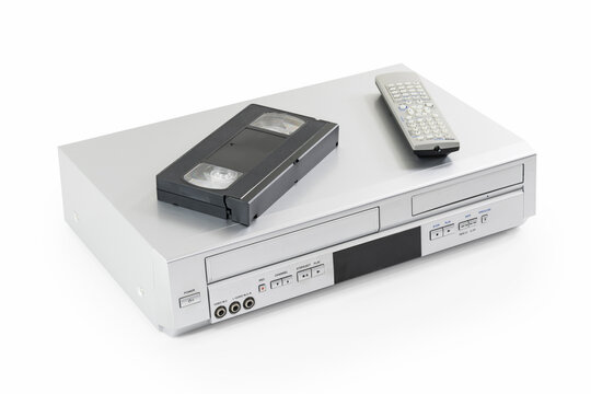 Old video cassette and disk player machine with remote controller, on white. 