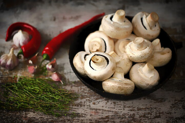 Fototapeta na wymiar Selective focus. Champignon mushrooms in a pan before cooking. Cooking vegan food.