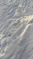 The texture of the snow cover in winter with traces