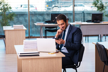 Young male employee working in the office