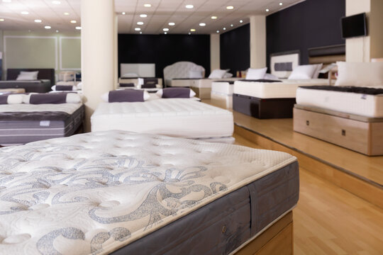 Closeup of new fashionable beautiful stylish orthopaedic mattress on display for sale in large furniture store