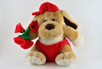 sweet stuffed dog holding a bouquet of red roses