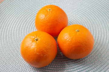 juicy fruits orange tangerines on a wicker mat