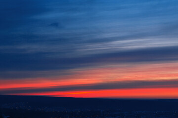 Beautiful sunset sky with stripes of red and blue