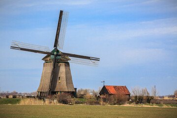 Fototapeta na wymiar Working Holland windmill in Netherlands