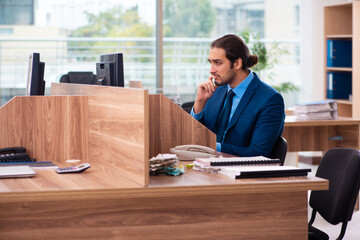 Young male employee working in the office