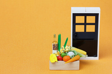 A wooden box with grocery stands by the door. Contactless home delivery of food concept.