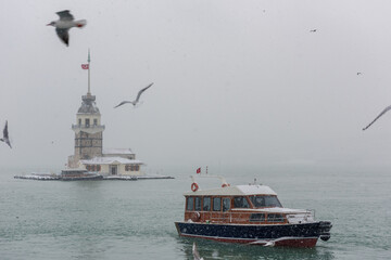 Snowy day in Uskudar with Maiden's Tower. Istanbul, Turkey.