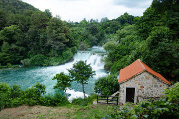 Fototapeta na wymiar house on the river and waterfall