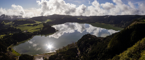 Panorama, view over Furnas lake, with clouds reflecting, Sao Miguel, Azores.