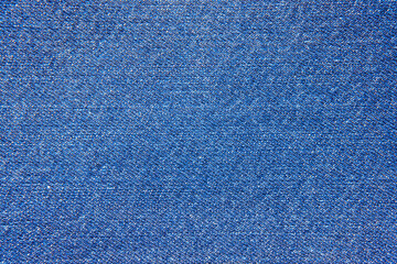 Fragment of a piece of denim close-up. The texture of the fabric.
