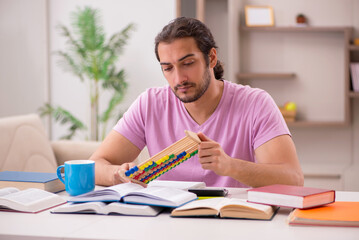 Young male student preparing for exams at home