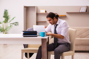 Young male employee working from home during pandemic