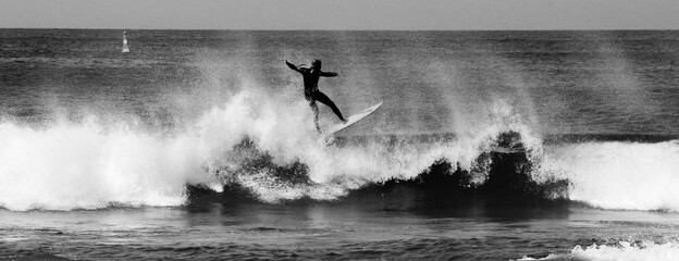 silhouette of a person surfing in the water
