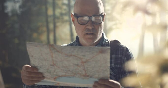 Lost tourist checking his location on a map