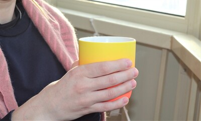 Woman holding a cup. drinking coffee. 