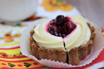 cheese cake with cream and berries. cherry jam