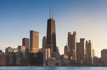 Chicago Illinois city sunset skyline and cityscape from Lake Michigan with John Hancock Building in...