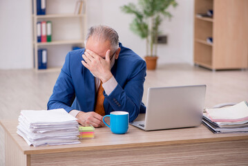 Old businessman employee sitting in the office