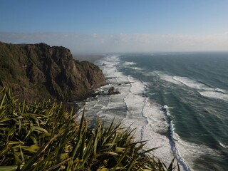Panorama view of steep rocky cliff coast at Mercer Bay Loop Track Piha Waikatere Ranges West...