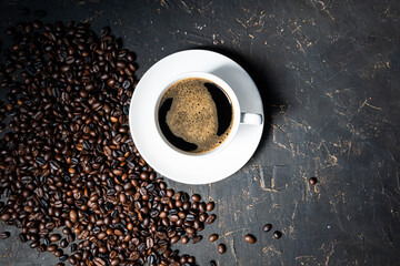 Coffee cup and beans on old kitchen table. Top view with copyspace for your text