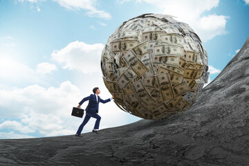 Businessman pushing away the dollar ball