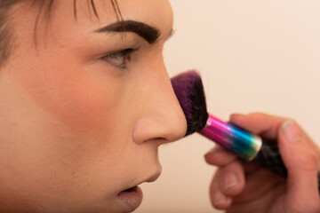 young man applying makeup
