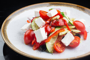 Greek salad with all cherry tomatoes, cucumber and lettuce and feta cheese, seasoned with olive oil