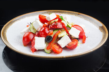 Greek salad with all cherry tomatoes, cucumber and lettuce and feta cheese, seasoned with olive oil