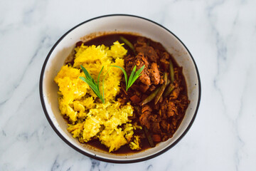 plant-based food, vegan turmeric rice and green beans stew with mock meat