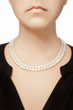 expensive white pearls necklace hanging on female decoltee of beautyful perfect woman looking rich and luxurious