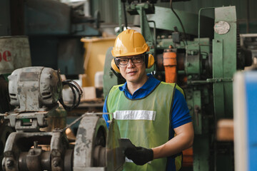 Professional worker asian man. Inspection technician, factory engineer, inspection of the machine condition in the factory. Inspection by technicians, industrial business, production machinery