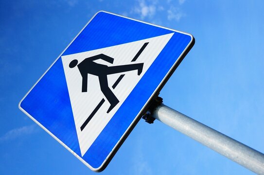 Low Angle Shot Of A Blue Zebra Crossing Traffic Sign