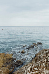Calm sea gently hitting the rocks