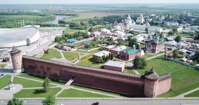 Scenic view from drone of Kolomna cityscape with medieval Kremlin and modern Speed Skating Center on spring day, Russia