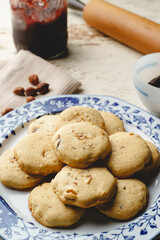Homemade hazelnuts cookies in a plate - front view close up baked sweet food traditional recipe - healthy eating concept