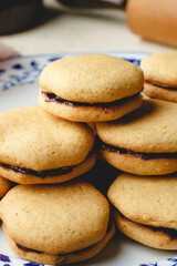 Homemade cookies with marmalade or fruit plum jam in a plate - close up front view baked sweet food traditional recipe - healthy eating concept