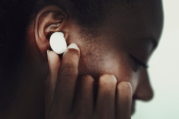 African American woman wearing wireless earbuds
