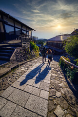 Couple walking together on the small street at Magome-juku village, Nagoya, Japan