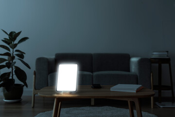 Digital tablet with blank screen on wooden table