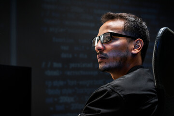 Man analysing binary code on virtual screen