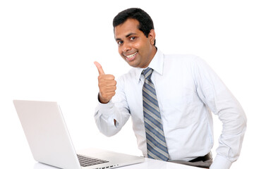 businessman with laptop showing thumbs up
