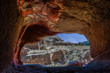 Jordan , Petra, view out from a cave of the Street of Facades. Tombs inside pink Sandstone rocks.