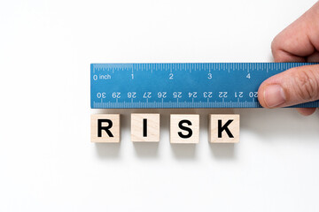 Measure the word risk with blue color ruler for risk assessment concept