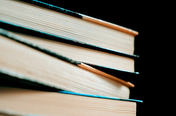 Books on a black background, selective focus, close-up.