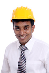 Young Indian architect posing to the camera on white background.