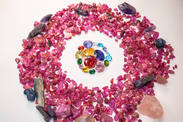 colorful diamonds in different size and many shape are place in the middle on a white ground...