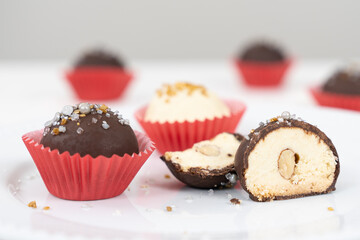 Dark and white chocolate coated almond London cookies in red paper cup